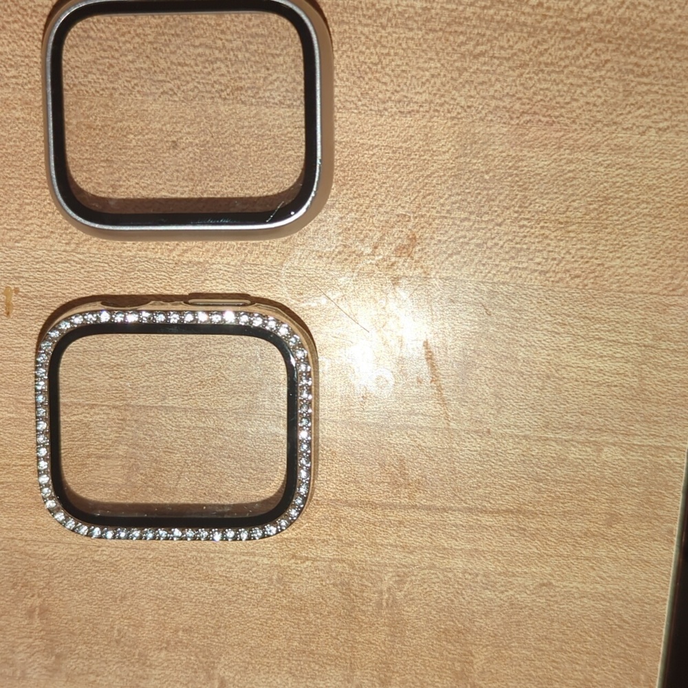 2 iPhone covers. One with rhinestones all around the other rose gold and black.
